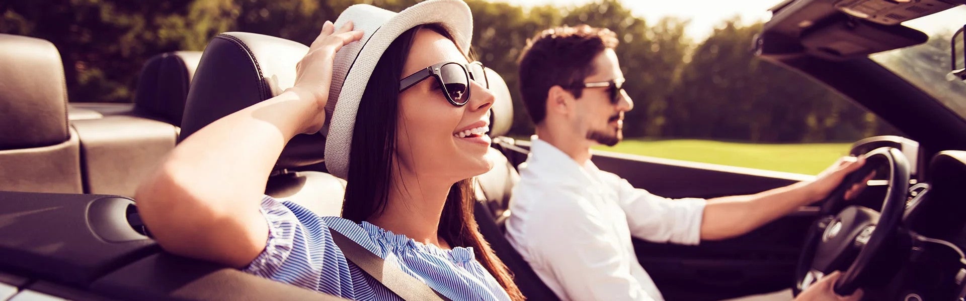 Happy couple driving a new car